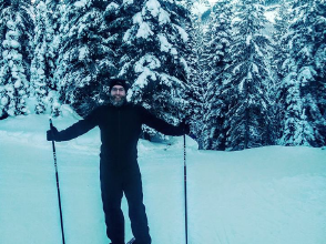 Person cross country skiing with the help of rehabilitation therapist
